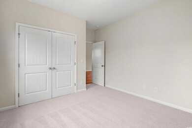 Unfurnished bedroom featuring carpet flooring and a closet