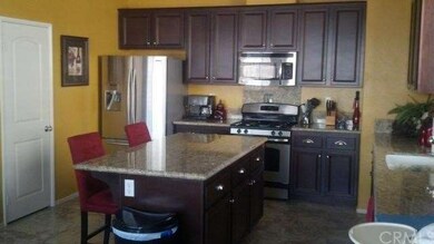 Kitchen with tile, granite, stainless steel applia