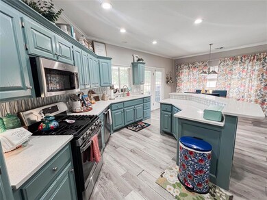 Kitchen featuring a kitchen island, appliances wit
