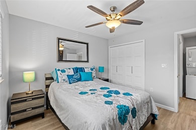 Bedroom with estacked washer and dryer, wood finis