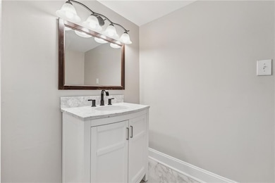 Bathroom featuring baseboards, marble finish floor