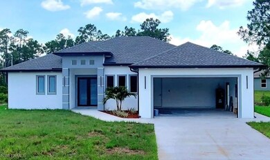 View of front of home featuring a garage, concrete