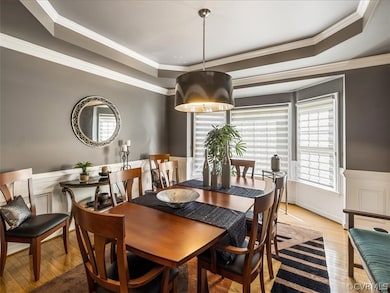 Inviting dining room with bay window, tray ceiling