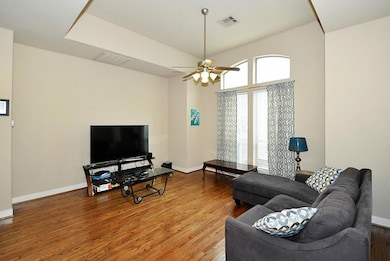 Living area with sunny bay window, high ceilings,