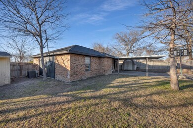 Back of property with a lawn, central AC unit, and