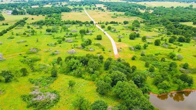 Birds eye view of property featuring a rural view 