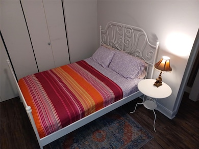 Bedroom with wood finished floors