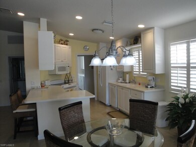 Kitchen from dining area. Note custom plantation shutters.