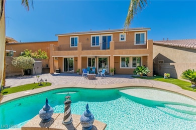 Back of house featuring a balcony, a patio area, a fenced backyard, stucco siding, and an outdoor fire pit