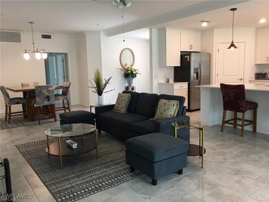 Living room with light tile patterned floors and a chandelier