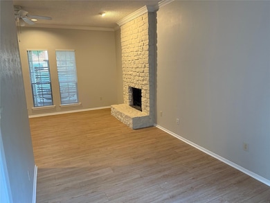 Unfurnished living room featuring a ceiling fan, 