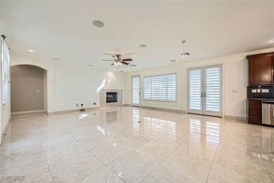 Unfurnished living room featuring arched walkways,