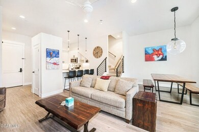 Living area featuring baseboards, recessed lightin