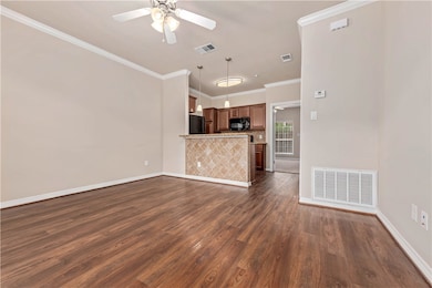Unfurnished living room featuring ceiling fan, dar
