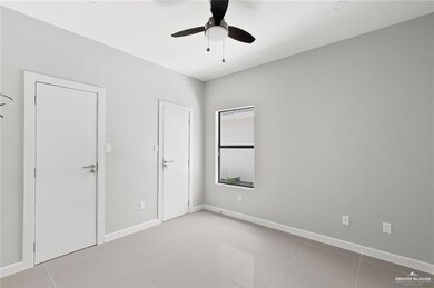 Tiled empty room with ceiling fan