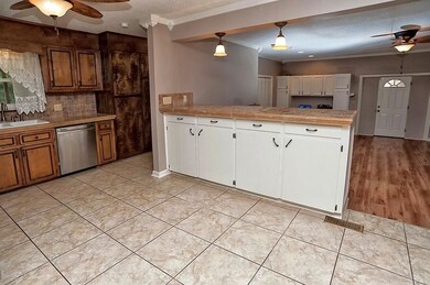 Granite countertops, tile backsplash, tile floors, and stainless steel appliances.