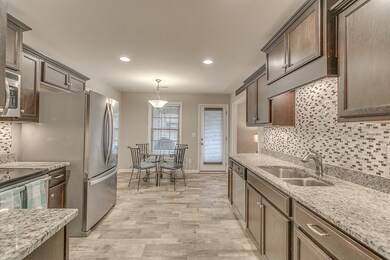 Tile backsplash and cozy casual dining with window