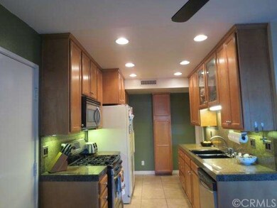 Kitchen with granite, custom ceiling high cabinets