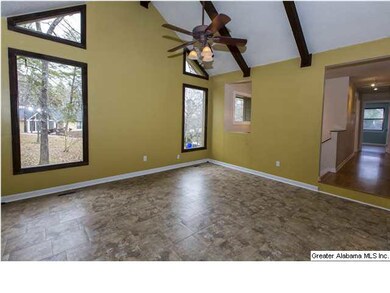 Family room has beautiful wood beam vaulted ceilin