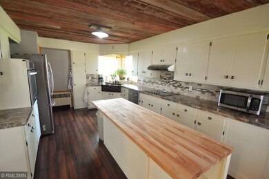 The kitchen has freshly painted cabinets, a tiled 