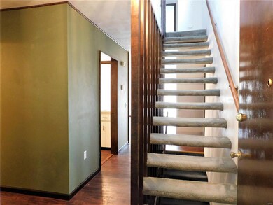 Nice, wood laminate flooring downstairs - open staircase to the second floor.