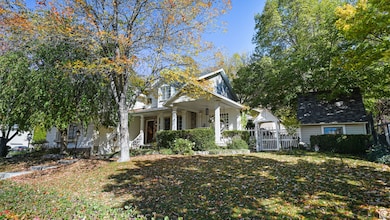 View of front facade featuring covered porch and a front lawn