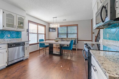 Kitchen featuring dark wood-type flooring, stainle