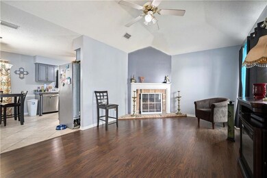 Living area with vaulted ceiling, a ceiling fan, l