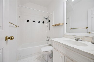 Tub/shower combo with tile surround.