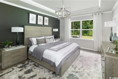 Bedroom with a chandelier, a tray ceiling, and orn