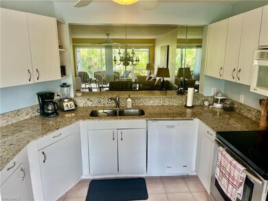 Kitchen featuring ceiling fan with notable chandel