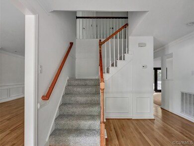 Stunning staircase! This home has been freshly pai