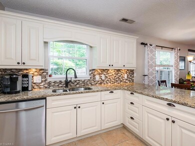 Kitchen Nicely updated with Tile backsplash, Granite Countertops, SS appliances and Tile floor