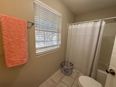 First floor full bathroom with neutral colors.