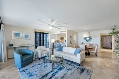 Living area featuring a ceiling fan and light tile patterned floors