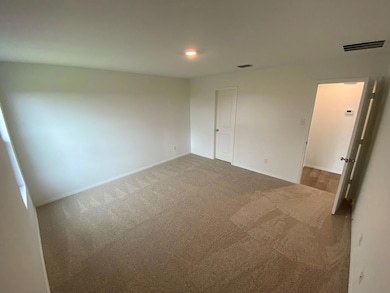 Unfurnished bedroom featuring carpet floors, visib