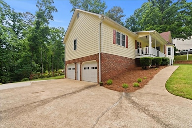 View of side of property with brick siding, a gara