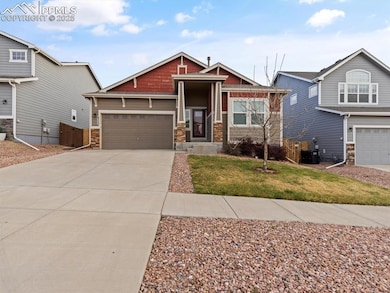 Craftsman-style home with a front lawn, stone sidi
