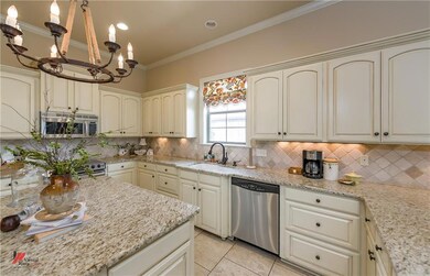 Granite and light cabinets grace this kitchen with