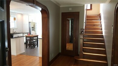 Enter into the large foyer with beautiful woodwork
