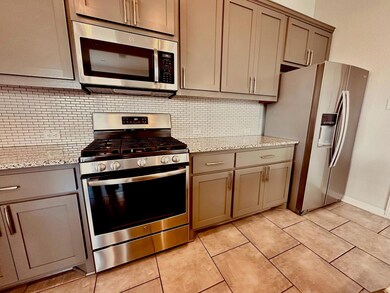 Kitchen featuring stainless steel appliances, gra