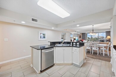 Kitchen featuring white cabinetry, a center island with sink, dishwasher, pendant lighting, and recessed lighting