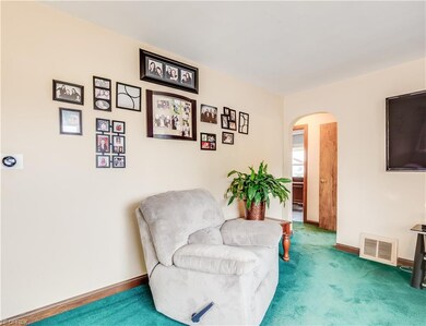Arched entry way to hallway keeps the family room 
