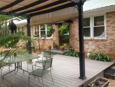 Front deck featuring outdoor dining space and a pergola