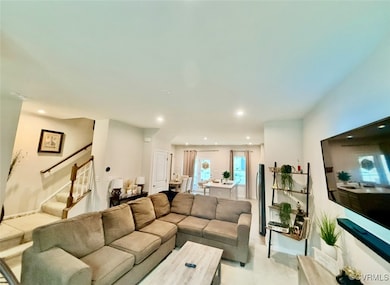 Living room featuring stairway and recessed lighti