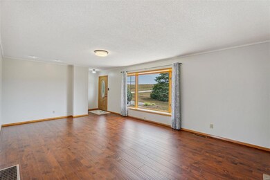 Enter through a beautiful hardwood and glass front