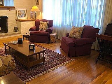 LIVING ROOM WITH FIREPLACE AND SOLID HARDWOOD FLOO