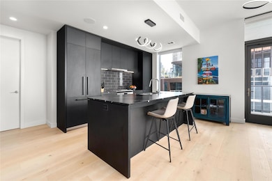 Kitchen featuring a breakfast bar, a sink, light 