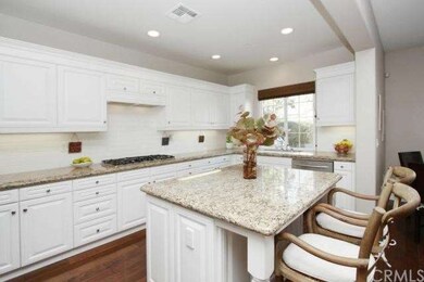 White cabinets, granite counters and stainless app