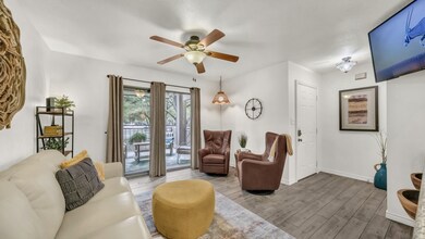 Living area with wood finished floors and a ceiling fan